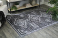 Ashley Furniture Arloman Rug with intricate pattern and soft texture, showcasing warm colors and detailed design.