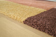 Close-up of the Ashley Furniture Gailmore Rug featuring intricate patterns and soft textures in warm neutral tones.