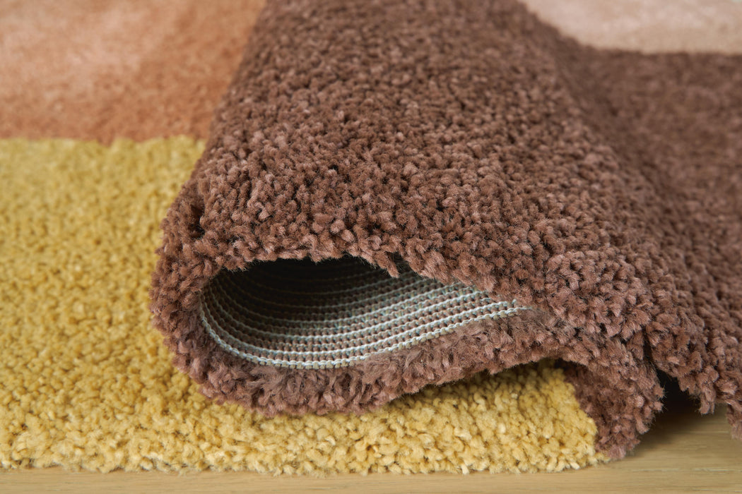 Close-up of the Ashley Furniture Gailmore Rug showing its detailed woven pattern and rich texture in neutral tones.