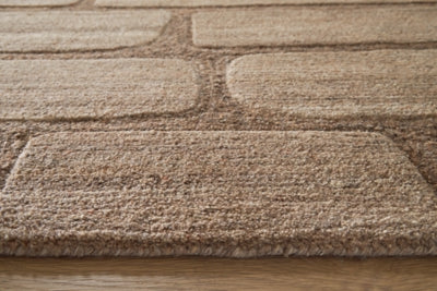 Close-up of Ashley Furniture Orest Rug showcasing intricate woven pattern and soft texture in neutral tones.