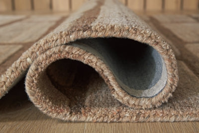 Close-up of the Ashley Furniture Orest Rug showing detailed woven pattern and soft texture in neutral tones.