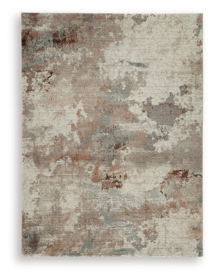 Ashley Furniture Jadenburg rug with intricate pattern in neutral tones, showcasing soft woven fabric and textured surface.