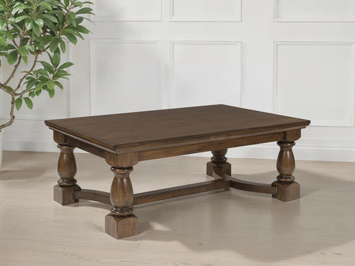 Ashley Furniture Sturlayne cocktail coffee table with a rectangular top and wooden finish, shown from a top-down view.