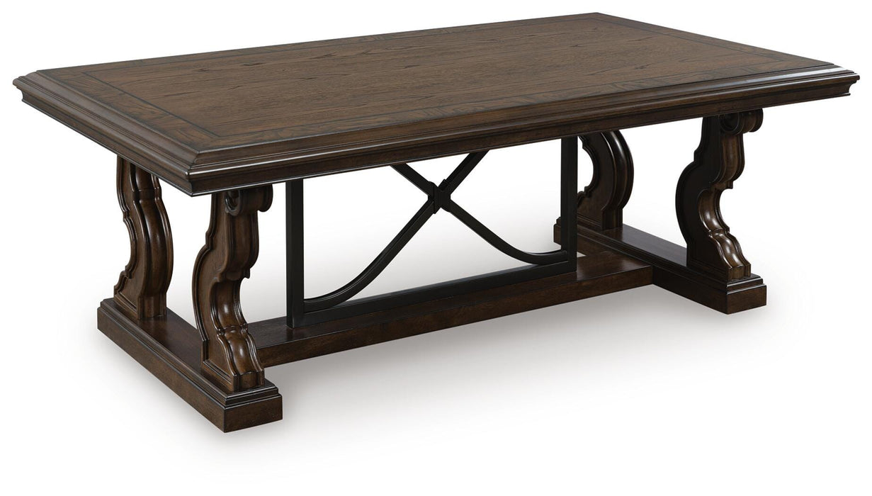 Ashley Furniture Maylee coffee table with a sleek wooden top and metal legs, shown from an angled side view.