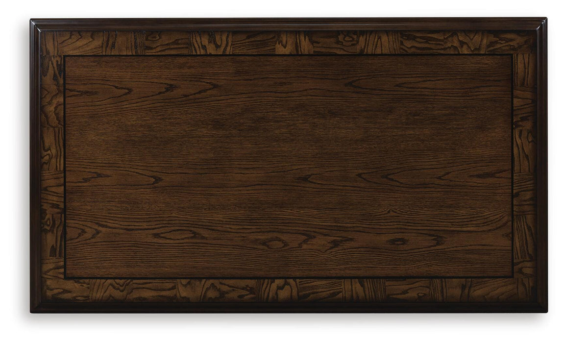Ashley Furniture Maylee coffee table with a sleek wooden top and modern design, perfect for living room decor.