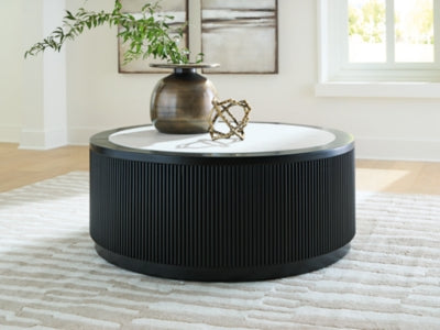 Grayman cocktail coffee table by Ashley Furniture with a gray finish and modern design, shown in a close-up view.