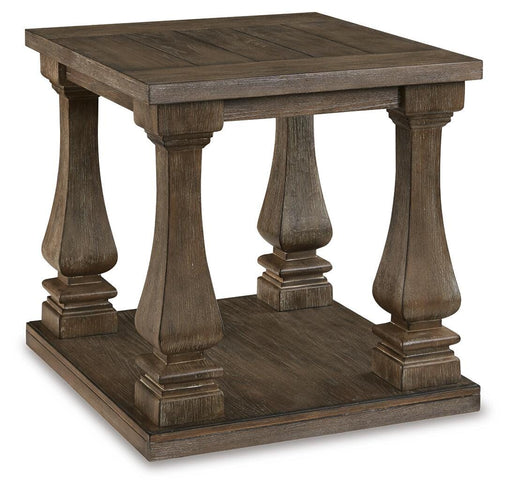 Ashley Furniture Johnelle end table with a dark wood finish and sleek design, shown from an angled side view.