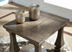 Ashley Furniture Johnelle end table with a sleek wooden top and sturdy legs, ideal for living room or bedroom decor.