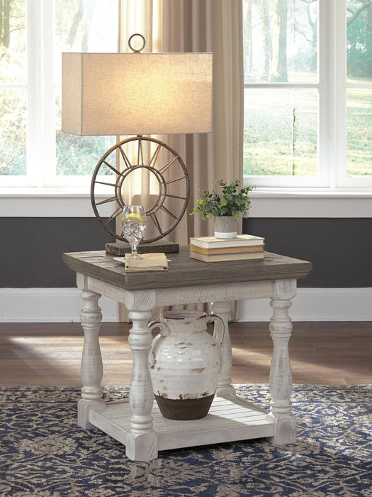 Ashley Furniture Havalance end table with a sleek wooden top and modern metal legs, shown in a close-up view.