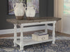 Ashley Furniture Havalance sofa console table with a sleek wood finish and modern design, shown in a cropped front view.