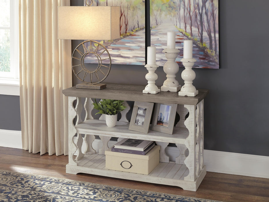 Ashley Furniture Havalance sofa console table with a sleek wooden design and modern accents, shown in a stylish indoor setting.