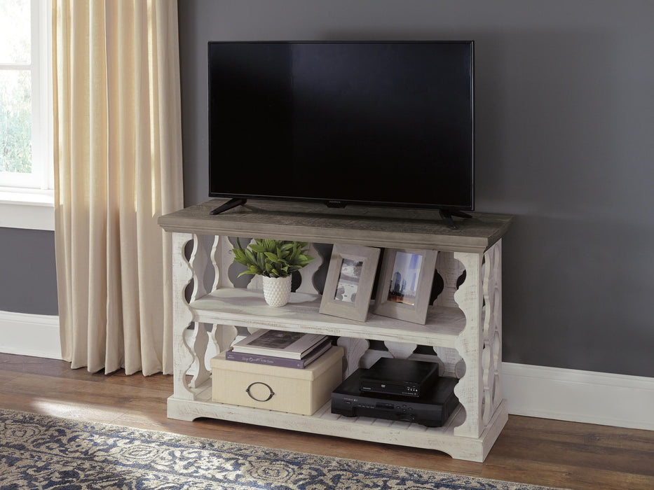 Ashley Furniture Havalance sofa console table with a sleek wood finish and modern design, shown in a close-up image.