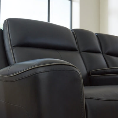 Ashley Furniture 5Z-Relaxation power reclining loveseat with console, featuring contrast welt accents and plush upholstery.