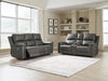Ashley Furniture Bleckley reclining living room set with sofa and loveseat, featuring plush cushions and dark upholstery.