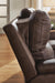 Ashley Furniture Bleckley reclining living room set with a plush sofa and matching loveseat, featuring padded armrests and reclining features.