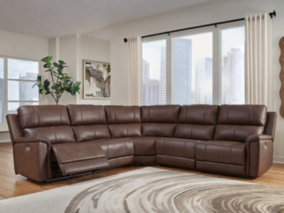 Ashley Furniture Bleckley power reclining sectional with plush cushions and dark upholstery, shown in a modern living room setting.