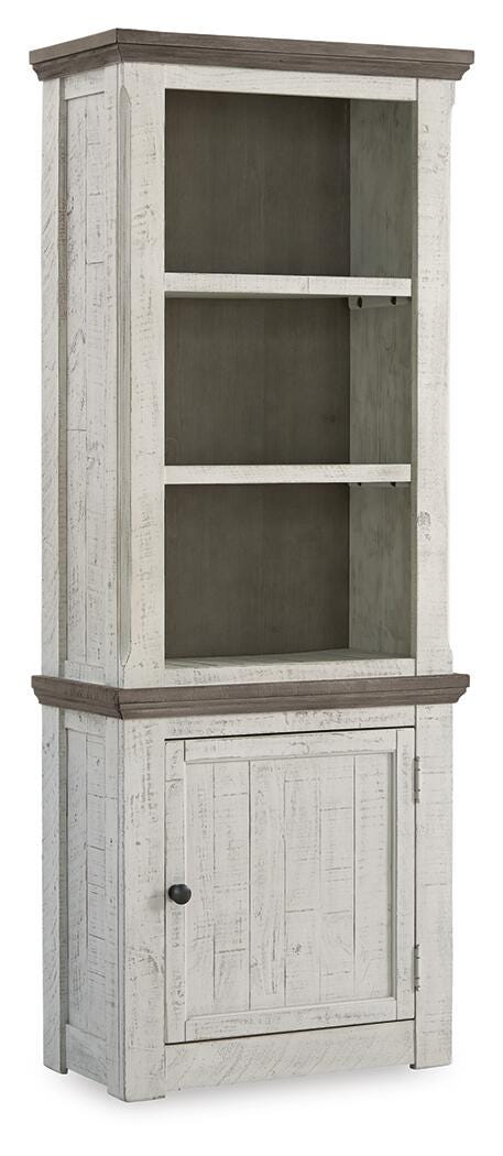 Ashley Furniture Havalance right pier cabinet with closed doors, wood finish, and modern design, shown from an angled side view.